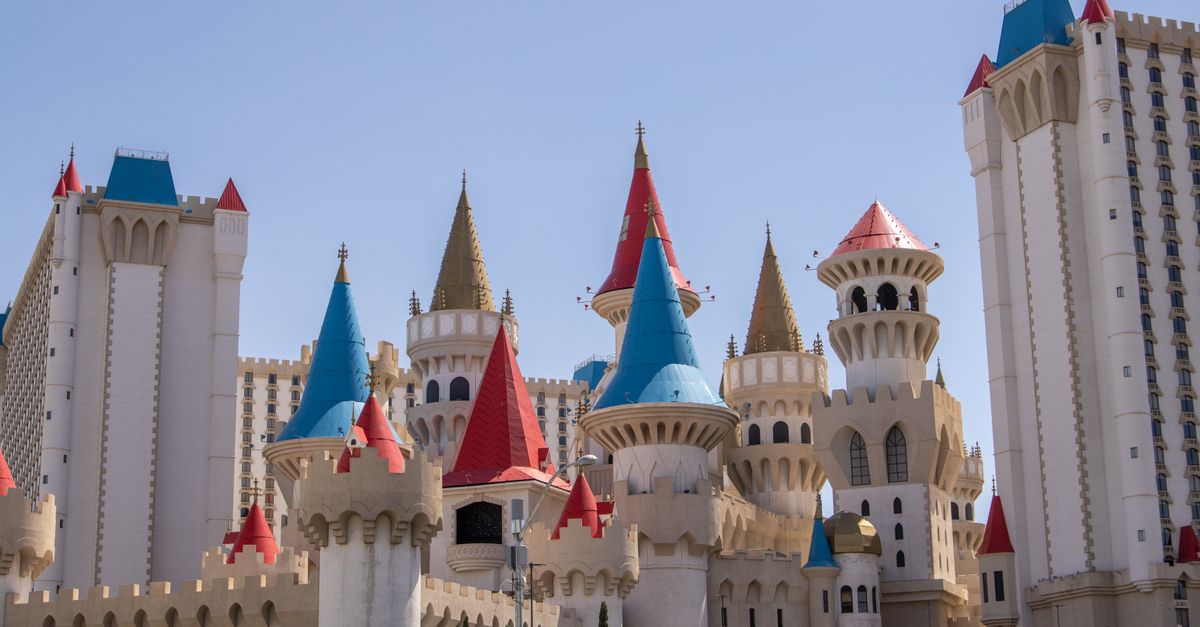 Vibrant castle-themed Excalibur Hotel in Las Vegas under a clear blue sky.